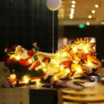 Χριστουγεννιάτικη Κρεμαστή Φιγούρα Αγιος Βασίλης σε Ελκυθρο και Ελάφια Μπαταρίας με Βεντούζα και 9 LED 25x13.4x2.6cm